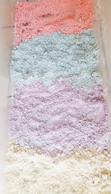 Unicorn sensory bin with colored cloud dough. Perfect for fine motor and alphabet practice for toddlers and preschoolers.