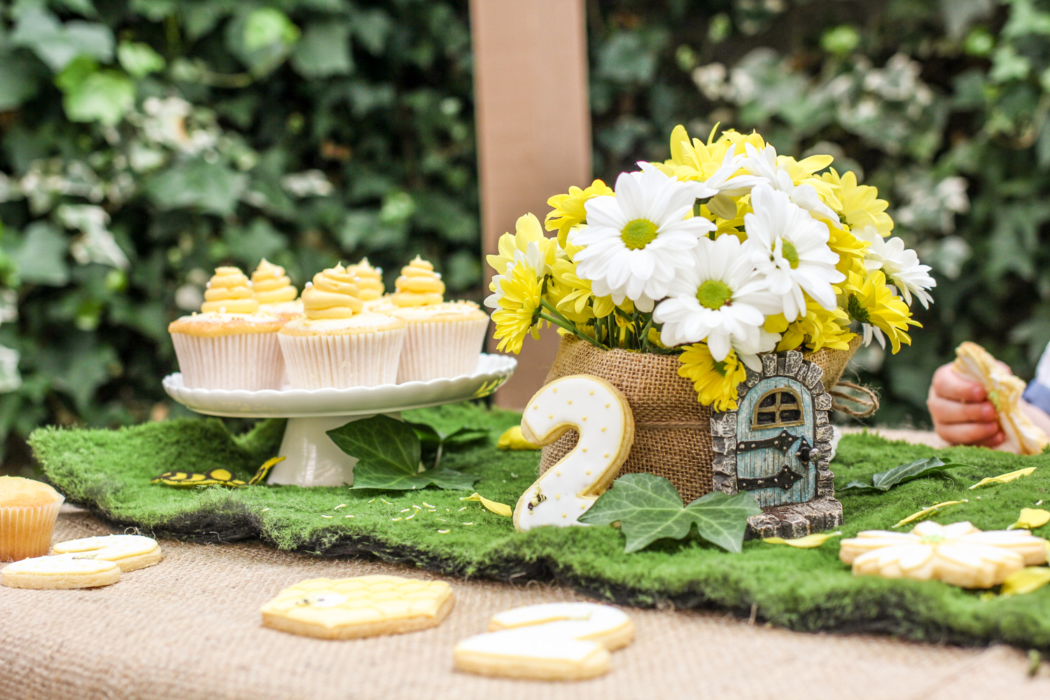 Beehive cupcake, bumble bee cookies on kids woodland theme party table For more children / kids party inspiration visit the Goldfields Girl blog