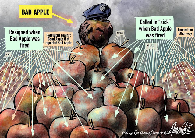 Mount of apples.  On top, an apple in a police cap labeled 