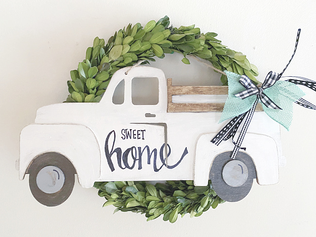 green boxwood wreath with truck