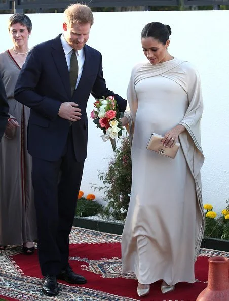 Meghan Markle wore a bespoke dress by Dior featuring draped sleeves and Birks Snowflake Snowstorm diamond earrings