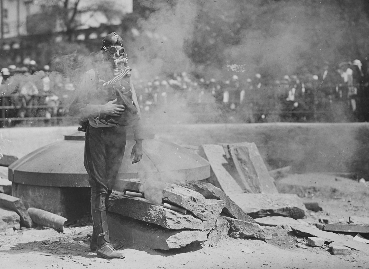 Original caption: A Boy Scout testing a gas mask in Union Square, New York City. 