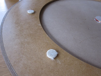 Crokinole - The felt feet, to cover the countersunk screws and protect table surfaces