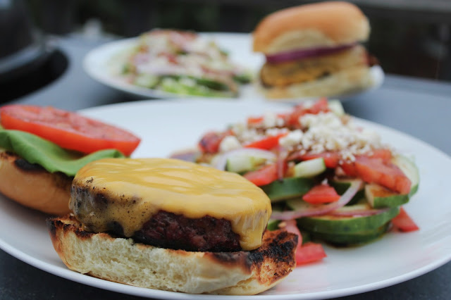 Cheeseburger with cucumber, tomato, feta salad