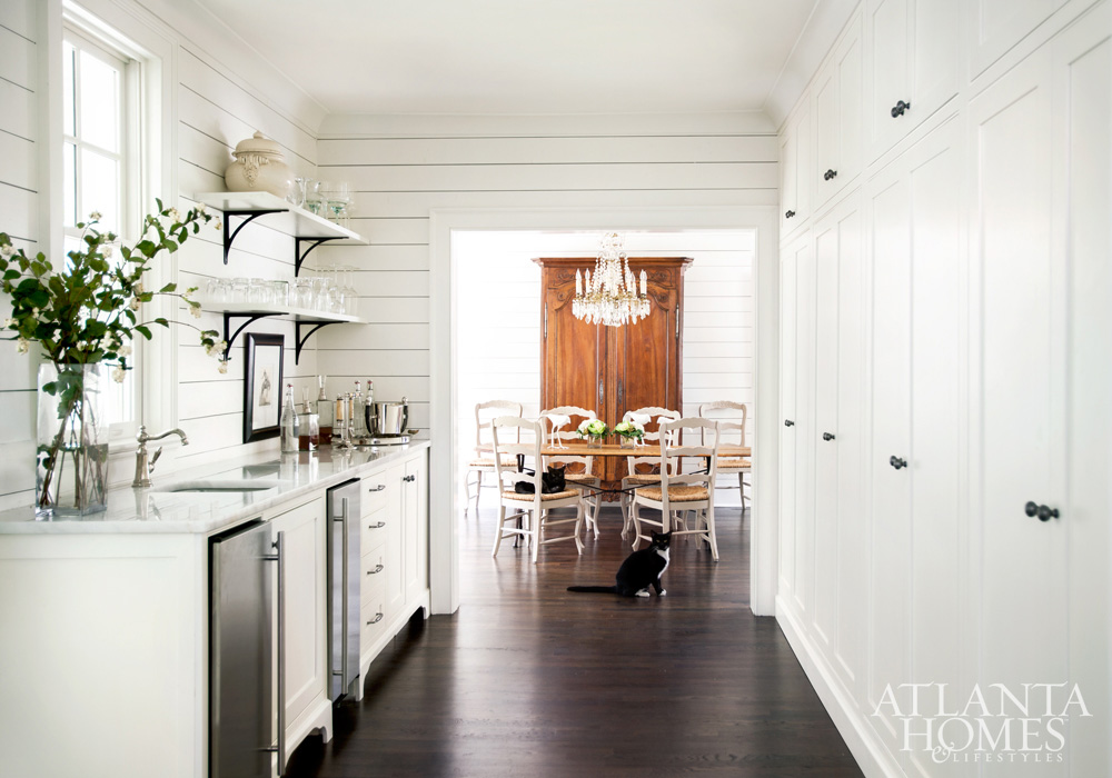 Modern farmhouse style white kitchen with sliplap, open shelves, and black accents