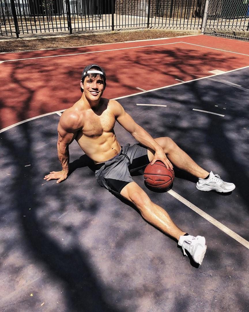 young-college-bro-smiling-teen-basketball-player-relaxing-pretty-male-legs