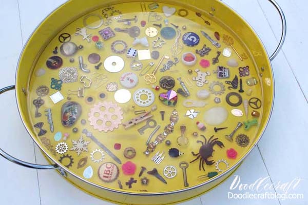 This I spy game resin serving tray filled with miniatures and trinkets is a fun DIY and would make a great gift! Fill the tray with little things from the junk drawer or little heirlooms that sit in a jewelry box collecting dust. With a thick layer of glossy resin, the trinkets stay in place and offer a smooth surface for using the tray for serving or a coffee table catch all.