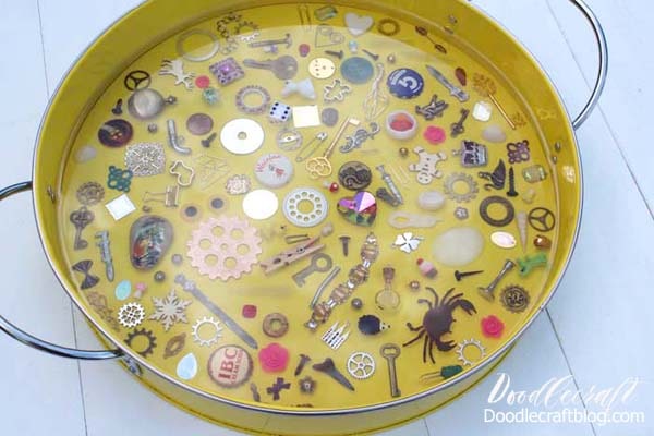 This I spy game resin serving tray filled with miniatures and trinkets is a fun DIY and would make a great gift! Fill the tray with little things from the junk drawer or little heirlooms that sit in a jewelry box collecting dust. With a thick layer of glossy resin, the trinkets stay in place and offer a smooth surface for using the tray for serving or a coffee table catch all. 