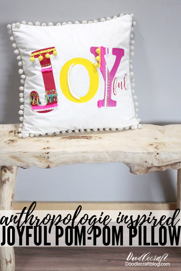 Make a joyful pom-pom pillow inspired by Anthropologie in this fun and simple tutorial. Using brightly colored iron-on vinyl and colorful trims and pom-poms to make the Joy pop!