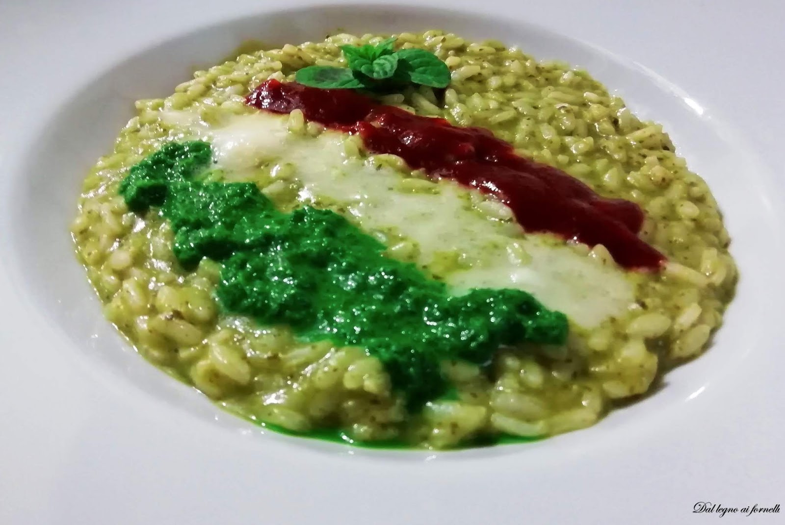 Risotto tricolore con pesto di rucola mantecato al taleggio.