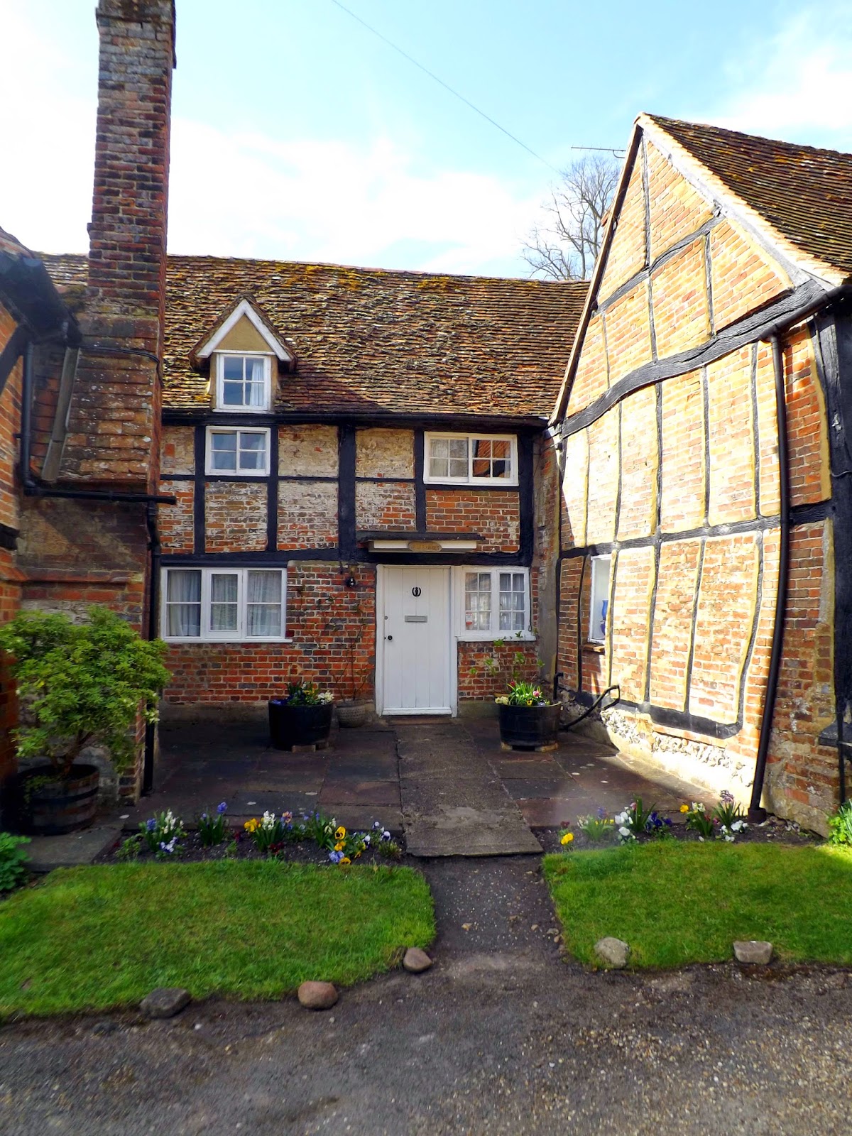 grey country kitchen diner with large island and oak dining table