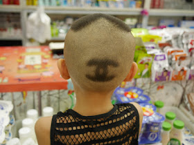 hair on back of boy's head shaved into a Chanel logo 