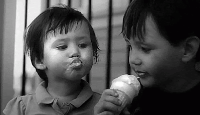 two kids sharing an ice cream