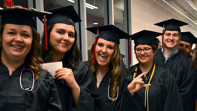 students in caps and gowns