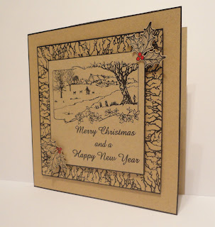 Christmas card on kraft card with black stamping and red holly berries