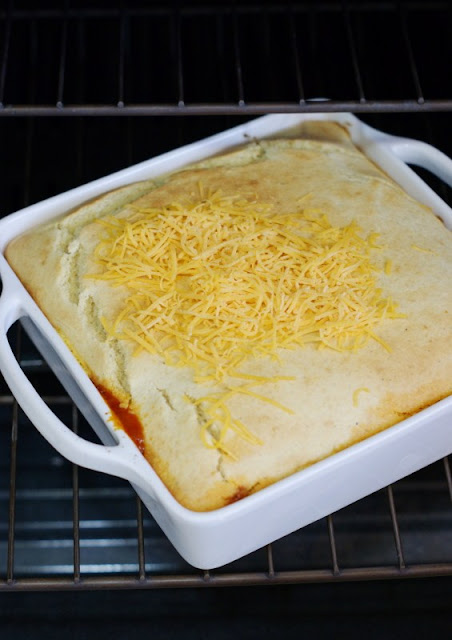 Shredded Cheddar Cheese Sprinkled on Tamale Pie Casserole's Partially-Baked Cornbread Topping Image
