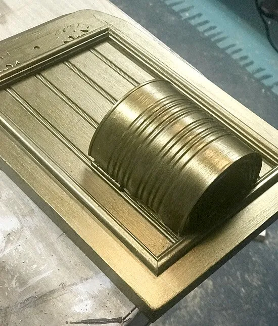 bronze recycled can on a cabinet door