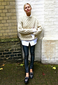 Pandora Skyes in a Cable Knit Sweater, White Shirt, Leather Pants, and Studded Loafers
