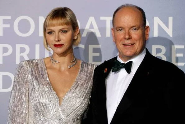 Princess Charlene wore a new v-neck sequin gown from Jenny Packham, and Brevis diamond necklace from Repossi. Pauline Ducruet red suit