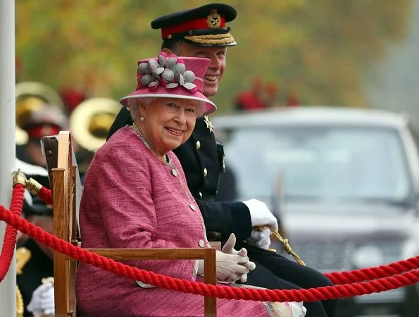 Britain's Queen Elizabeth II at the Hyde Park. Style of Queen Elizabeth, Fashion pink coat, dress, and clutch bag