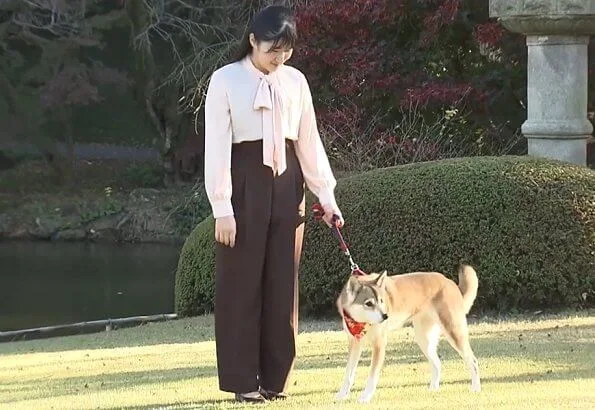 Japanese Princess Aiko wore a pink pussy-bow silk blouse. Princess Aiko with her dog Yuri at Akasaka