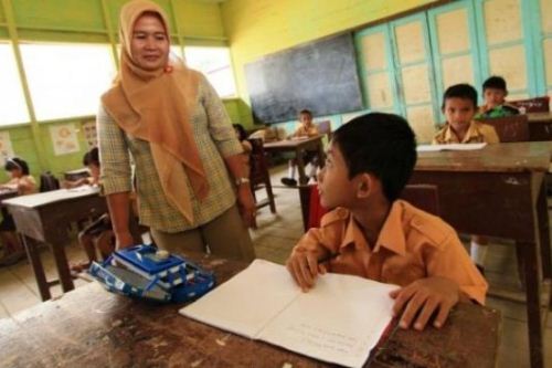 guru muslimah menyampaikan materi pelajaran