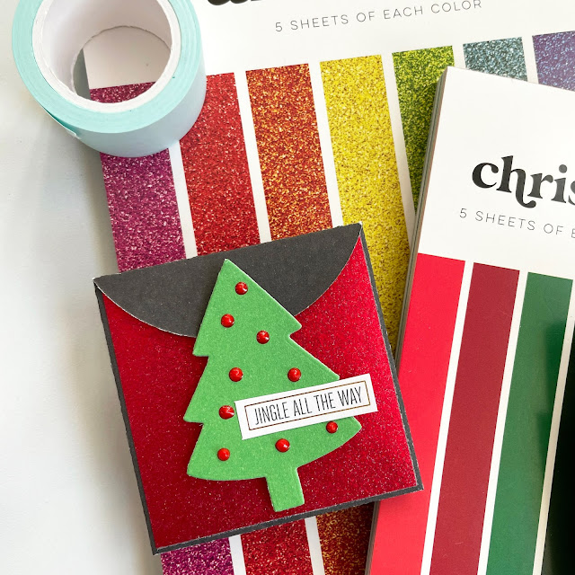 DIY Christmas Gift Card holder made with: Scrapbook.com rainbow glitter paper, Christmas smooth cardstock; pops of color rudolph red, nested fir tree die, mini envelopes die, mint tape
