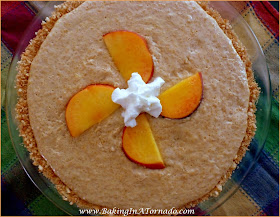No Bake Spiced Peach Pie: Fresh peaches spiced with a kick, blended into a creamy center and served in a cookie crust. No need to heat up the oven, this pie is no bake. | Recipe developed by www.BakingInATornado.com | #recipe #pie #dessert