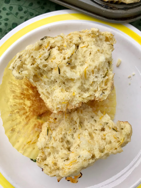 Plate with a lemon dandelion muffins split in half.
