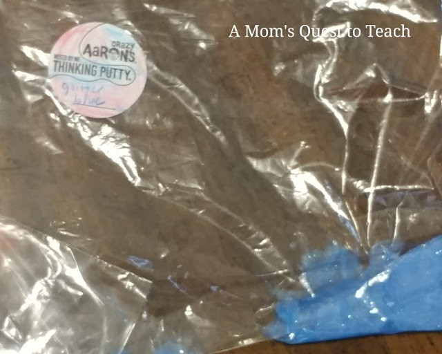 Crazy Aaron's Thinking Putty® label and blue mixed putty in plastic bag