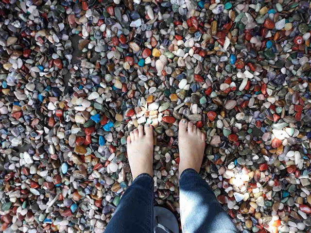 Feet on a bed of gemstones