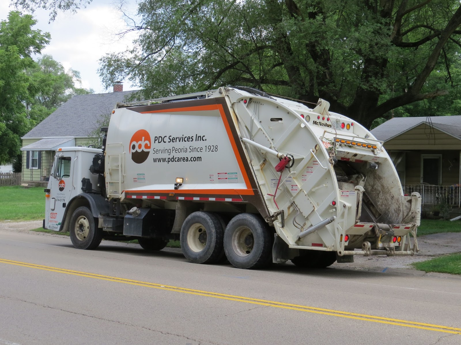 Lensing and Shuttering Peoria Disposal Company garbage truck