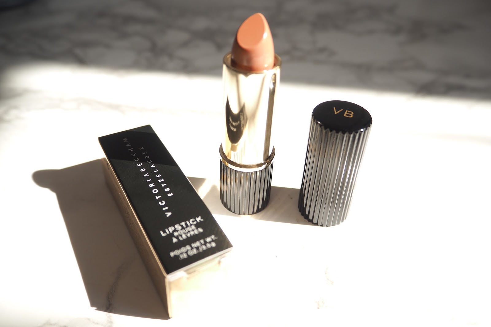 Victoria Beckham X Estée Lauder Makeup a little pop of coral.