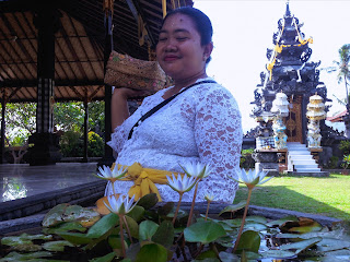 Woman And The Lotus Flower Giving Offerings At Dalem Temple Ringdikit, North Bali, Indonesia