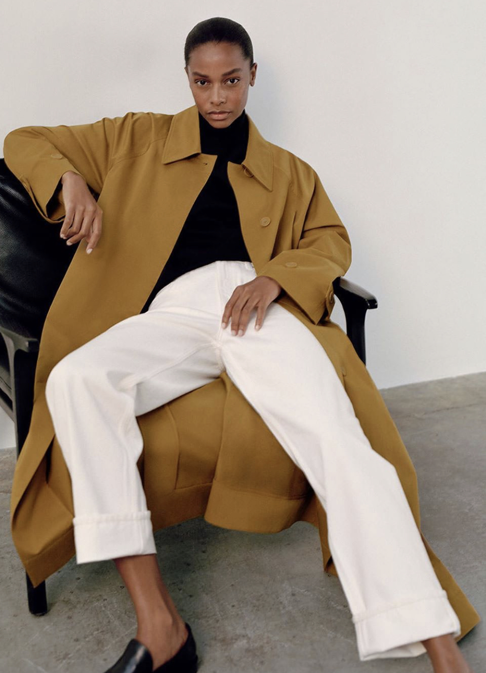 5 Minimalist Fall Outfit Ideas — Capsule Wardrobe with camel trench coat, black top, white jeans, and black loafers