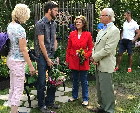 Queen Silvia wore a red long blazer for SilviaBo project at Ikea in Älmhult and visit the Themed Gardens exhibition at Solliden