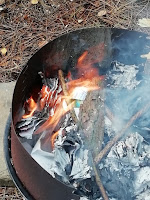 A fire burning in a metal fire bowl