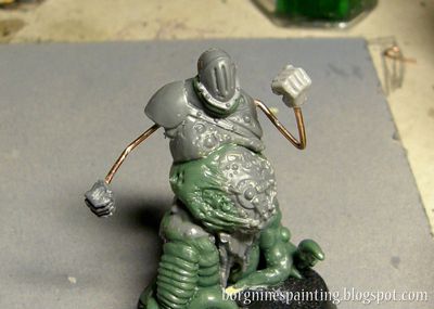 Unpainted, converted Putrid Blightking miniature with hands being made out of copper wires - the starting point for the greenstuff sculpting.
