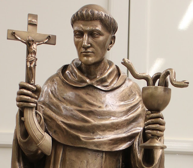 Why is St. Louis Bertrand holding a crucifixpistol and a snakefilled