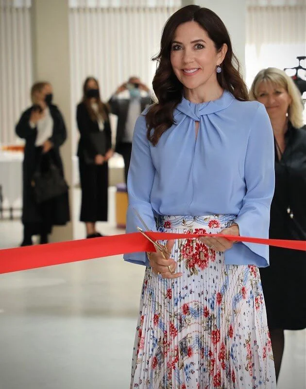 Crown Princess Mary wore a flare sleeve knot blouse from Victoria Beckham, and sunray pleated scarf print skirt from Paul and Joe