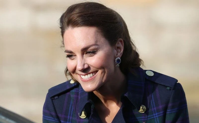 Kate Middleton wore a full length marlborough heather tartan trench coat  from Holland Cooper. Joseph metallic knitted skirt