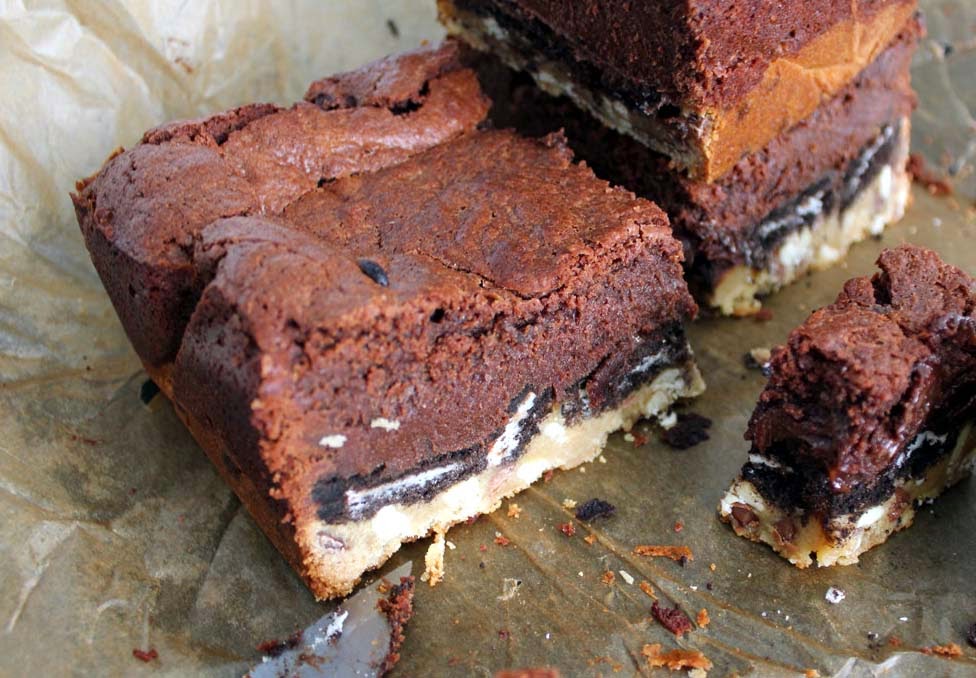 Slutty Brownies Made From Brownie and Chocolate Chip Cookie Layers Sandwiching An Oreo Cookie