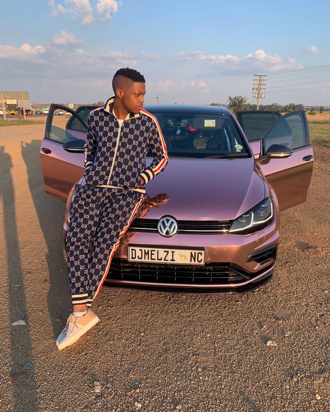 DJ Melzi Poses with his customized cars