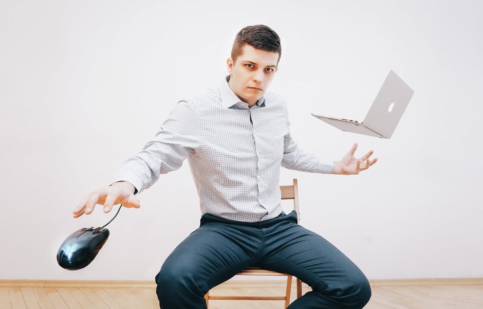 Man in Gray Dress Shirt and Making Tricks