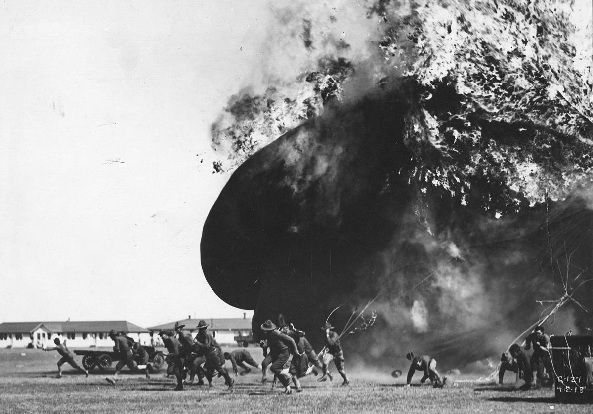 Men run from an exploding balloon at Post Field, Fort Sill, Oklahoma, on April 2, 1918.