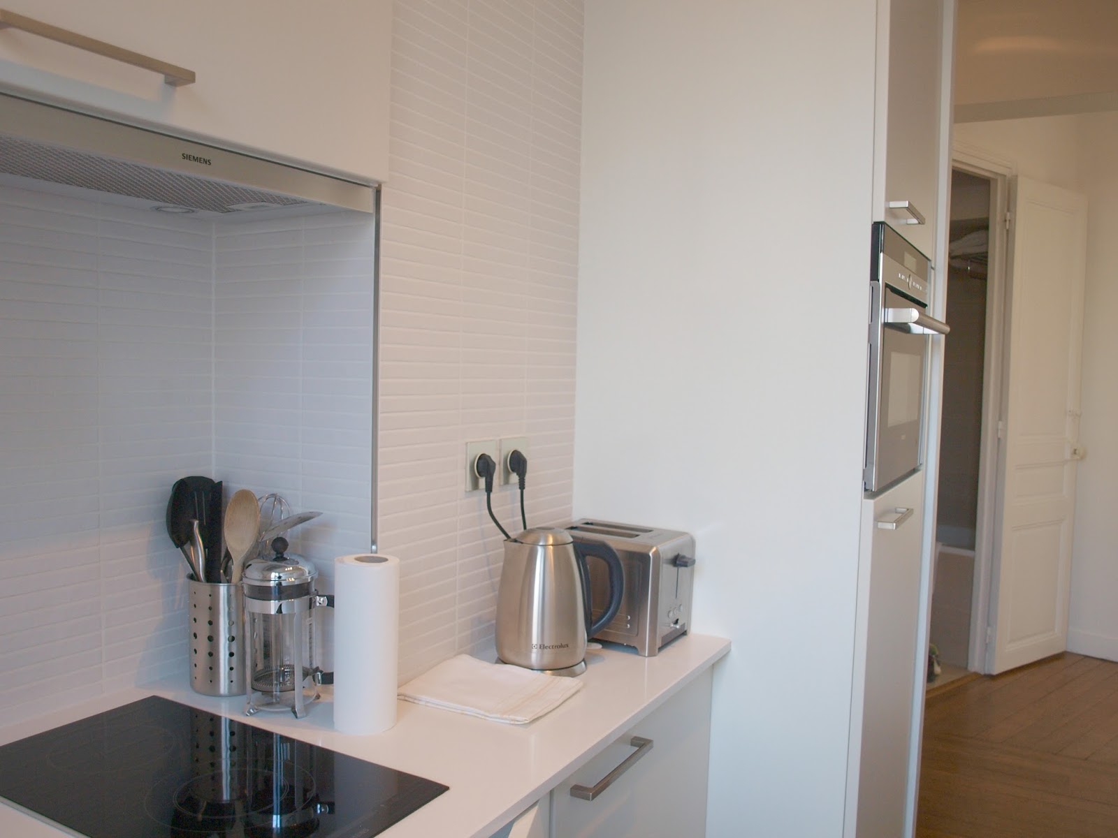 Small modern white kitchen in Paris apartment - by Hello Lovely Studio