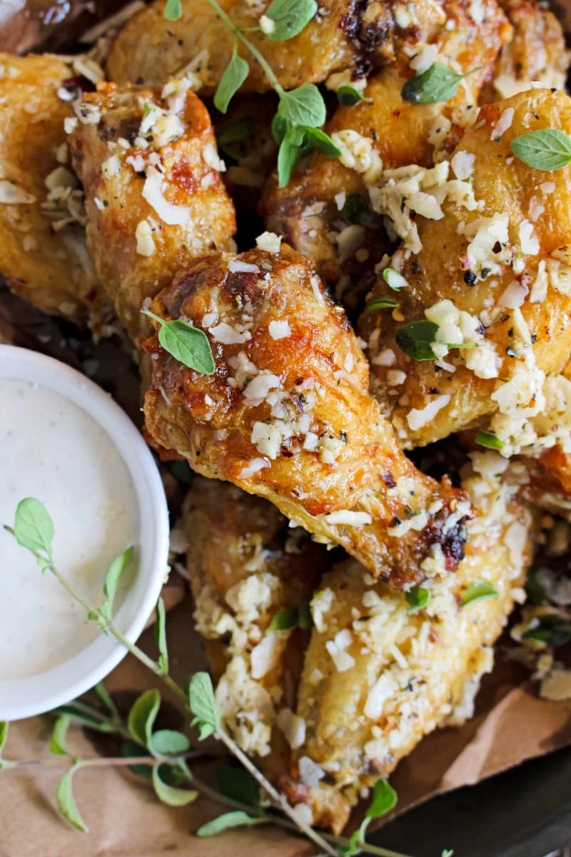 Air Fryer Garlic Parmesan Chicken Wings are extra crispy wings tossed in seasoned garlic butter sauce and parmesan cheese. Try them dipped in caesar dressing and you'll be hooked! #chickenwings #appetizer