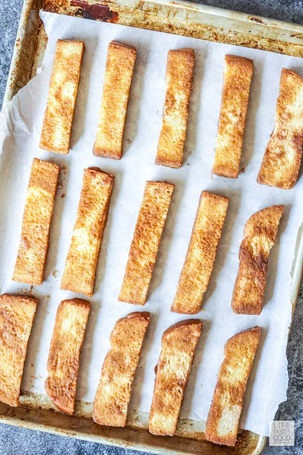 How to make french toast sticks- bread dipped in egg mixture and coated with cinnamon sugar ready to bake