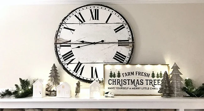 Mantel with houses, greens, trees and clock