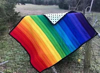 striped rainbow baby quilt.